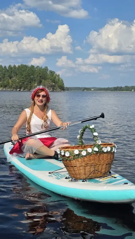 Julia wearing a red hat on the SUP board