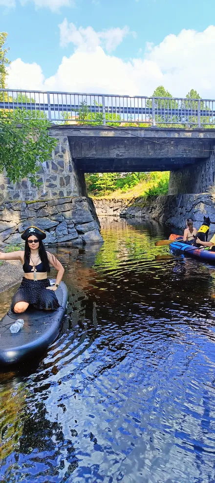 Julia dressed as a pirate paddling on the lake